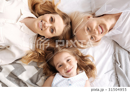 Charming three females of different age lying head Charming three females of different age lying head 31504955