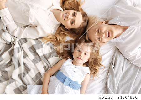 Beautiful females of three generations lying head Beautiful females of three generations lying head 31504956