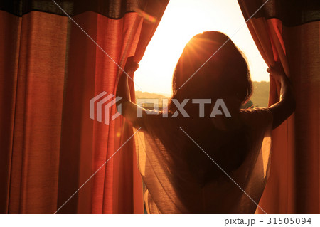 young woman stand in the room open curtain  31505094
