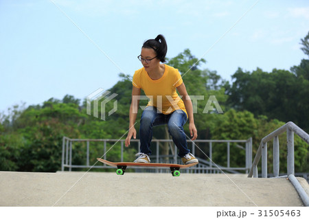 woman skateboarder skateboarding at skatepark 31505463