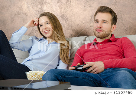 Couple enjoys free time and playing video games. Couple enjoys free time and playing video games. 31507466
