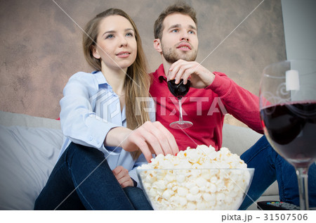 Couple enjoys free time watching TV Couple enjoys free time watching TV 31507506