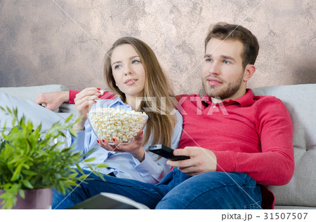 Couple enjoys free time and watching tv Couple enjoys free time and watching tv 31507507