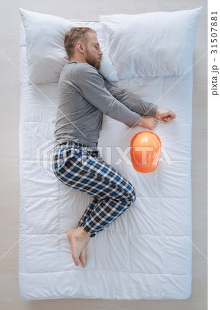 Serious professional engineer lying on the bed Serious professional engineer lying on the bed 31507881