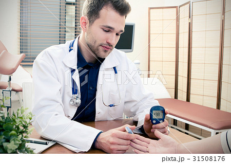 Doctor measuring of blood sugar for diabetes Doctor measuring of blood sugar for diabetes 31508176