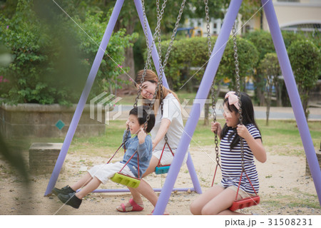 asian family swinging on the playground 31508231