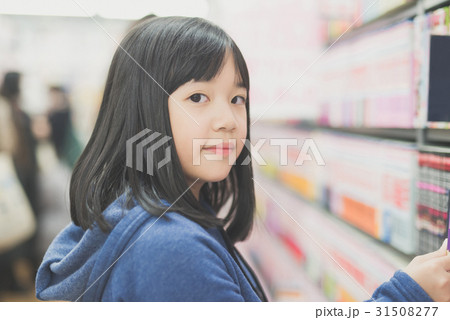Asian girl in a bookstore Asian girl in a bookstore 31508277