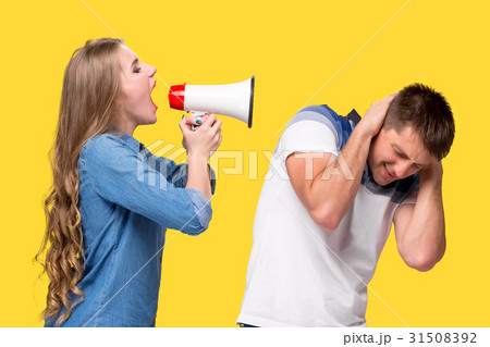 Woman shouting in megaphones at each other 31508392