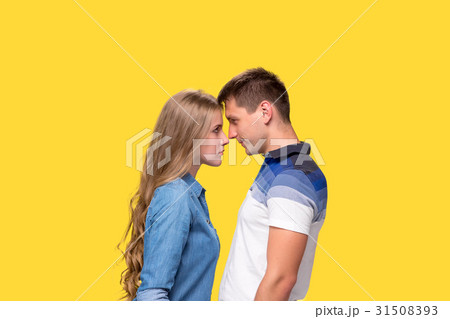Portrait of a young couple standing against gray 31508393