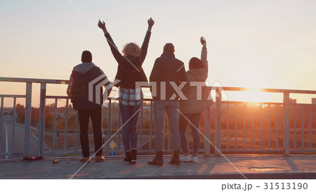 Family of four stands at barrier to observe nature Family of four stands at barrier to observe nature 31513190