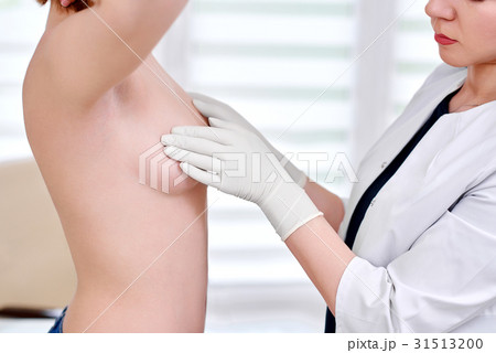 Young woman getting breast examination at the Young woman getting breast examination at the 31513200