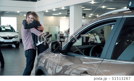 Man Surprising Woman with New Car In Show Room 31513267