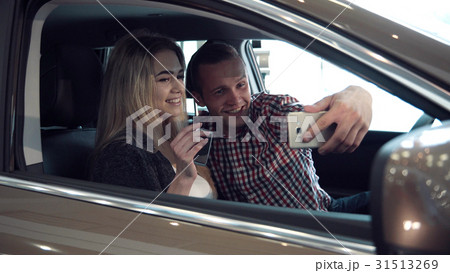 Excited young couple buying a new car and make 31513269