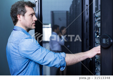 Handsome smart man doing his job Handsome smart man doing his job 31513348