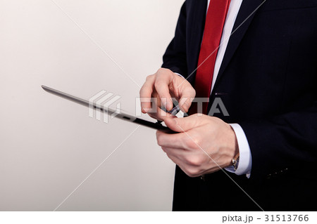 Teacher working on a tablet, close up, on a white 31513766