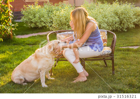 Happy family playing with their dog on a sunny day Happy family playing with their dog on a sunny day 31516321
