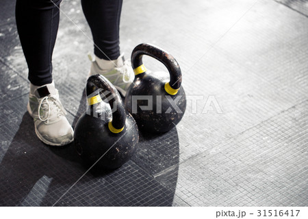 Kettlebell on floor. Girl training in gym Kettlebell on floor. Girl training in gym 31516417