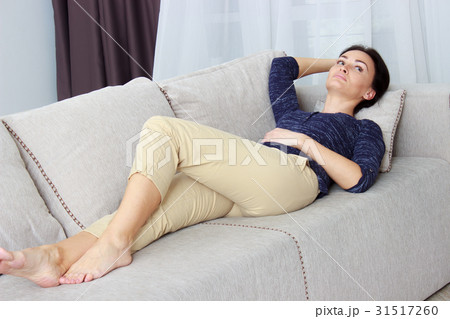 beautiful young woman lying on the couch 31517260