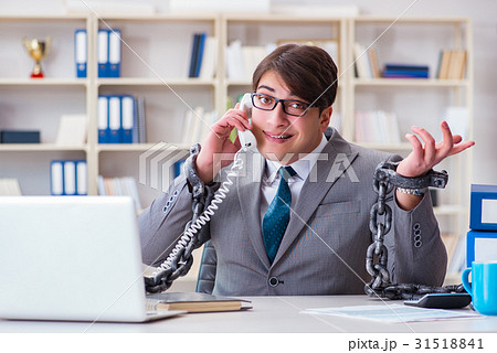 Businessman tied with chains to his work 31518841