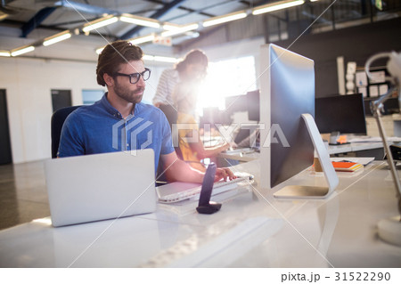 Casual businessman using computer Casual businessman using computer 31522290