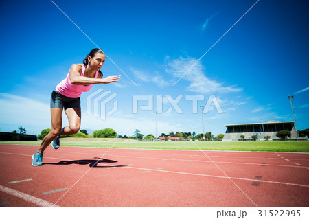 Female athlete running on the running track 31522995