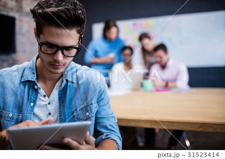 Hipster using a tablet computer Hipster using a tablet computer 31523414