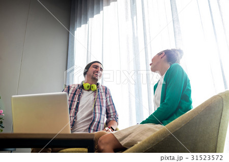 Coworkers talking and laughing Coworkers talking and laughing 31523572
