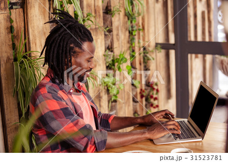 Profile of hipster man using laptop 31523781