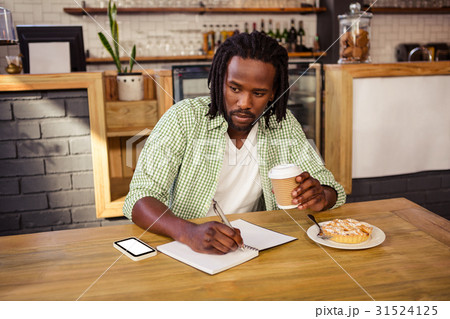Man writing in a notebook 31524125
