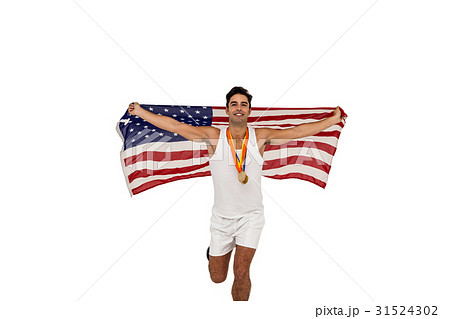 Athlete posing with gold medals and american flag after victory Athlete posing with gold medals and american flag after victory 31524302