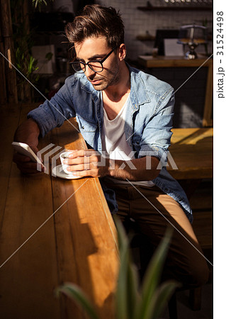 Man holding a cup of coffee Man holding a cup of coffee 31524498