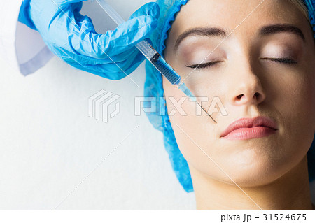 Woman receiving botox injection on her lips 31524675