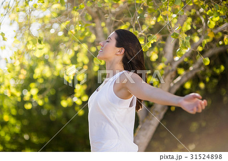Beautiful woman standing with arms outstretched 31524898