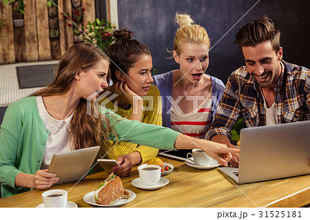 Friends using technology Friends using technology 31525181