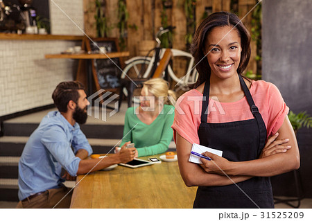 Waitress standing with arms crossed 31525209