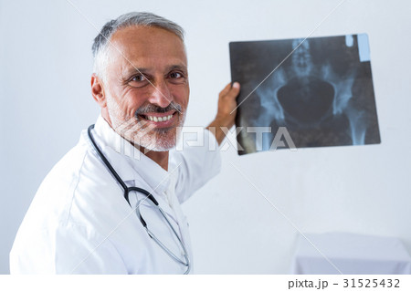 Male doctor holding x-ray Male doctor holding x-ray 31525432