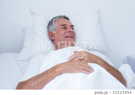 Senior man lying on bed Senior man lying on bed 31525454