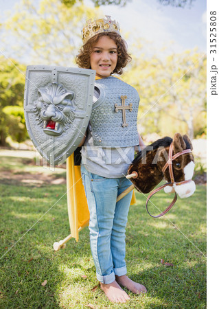 Cute boy standing and pretending to be a knight 31525808