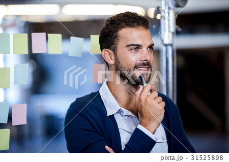 Businessman smiling and reflecting 31525898