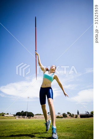 Female athlete throwing a javelin Female athlete throwing a javelin 31525939