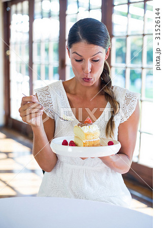 Woman having a pastry in restaurant Woman having a pastry in restaurant 31526144