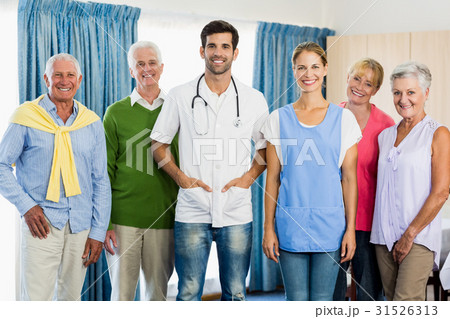 Nurse and seniors standing together 31526313