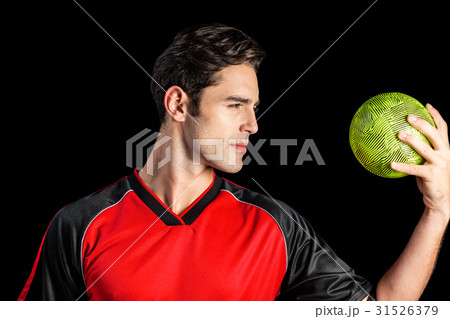 Confident athlete man holding a ball 31526379