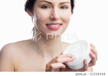 Woman applying a cream Woman applying a cream 31526438