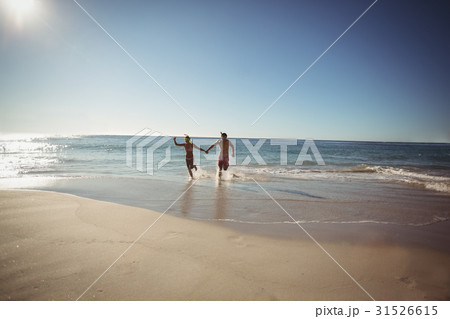 Couple running on beach Couple running on beach 31526615