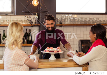 Bartender serving coffee to customers 31526622
