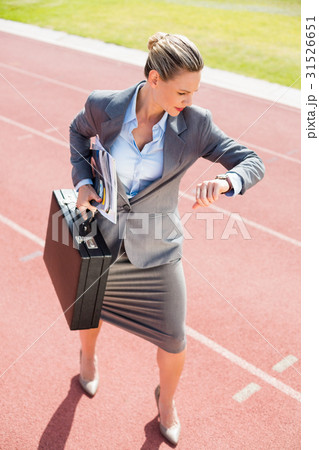 Businesswoman with briefcase in ready to run position Businesswoman with briefcase in ready to run position 31526651