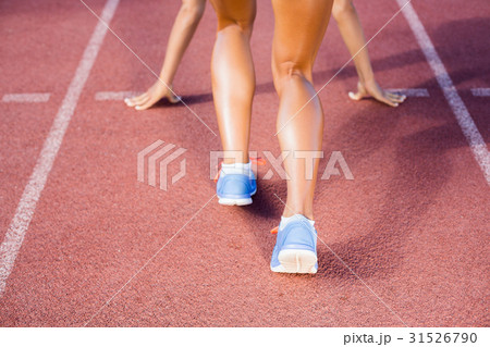 Female athlete ready to run on running track 31526790