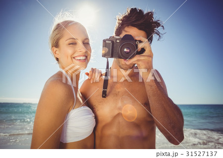 Couple clicking photographs from camera Couple clicking photographs from camera 31527137