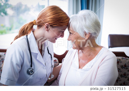 Smiling doctor and patient looking face to face 31527515